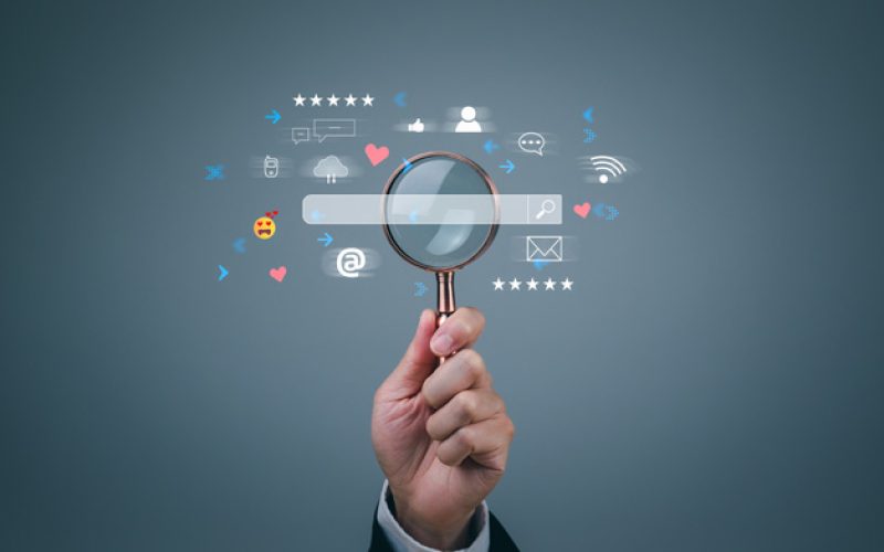 hand-with-magnifying-glass-with-search-bar-design-in-front